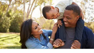 A Family Laughs Together in the Park.