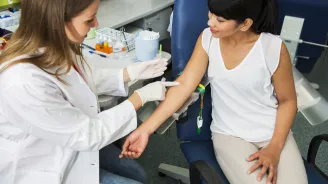 Woman prepares to have her blood drawn