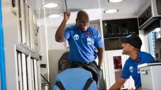 EMS workers in the back of an ambulance.