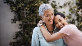 M teenage girl hugs her grandmother