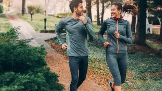 Two friends jogging in a park