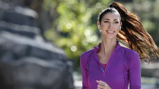 A Young Woman Runs Through the Park.