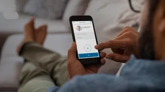 Man using app on a smartphone for a video visit