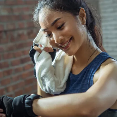 A runner takes a break to check her heart rate.