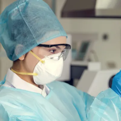 A woman analyzing a test sample.