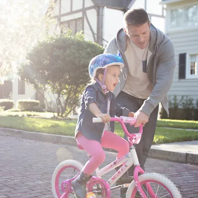Dad taking his daughter on a bike ride.