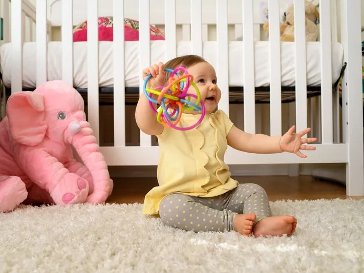 Baby plays with her toy at home