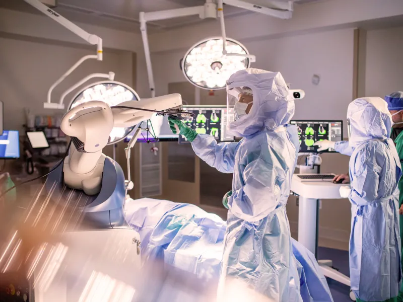 Doctors in a surgery room and using technology 