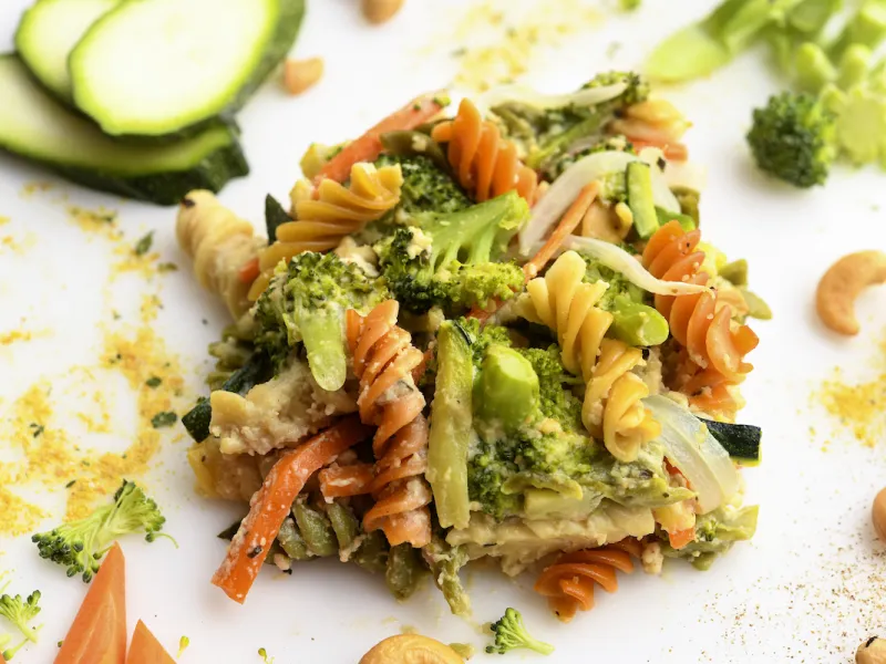 Square of veggie-pasta casserole with zucchini garnish