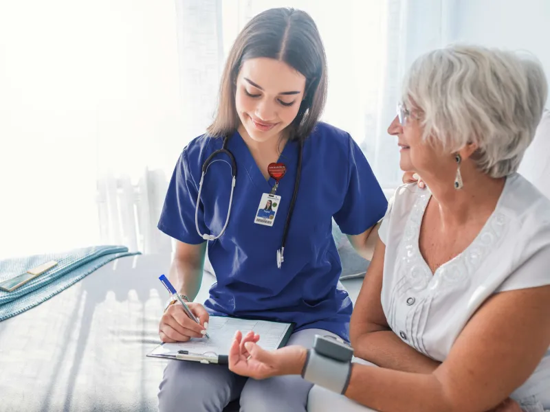 Nurse checking patients blood pressure.