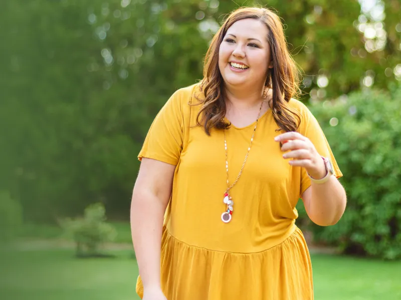 woman outside in yellow dress