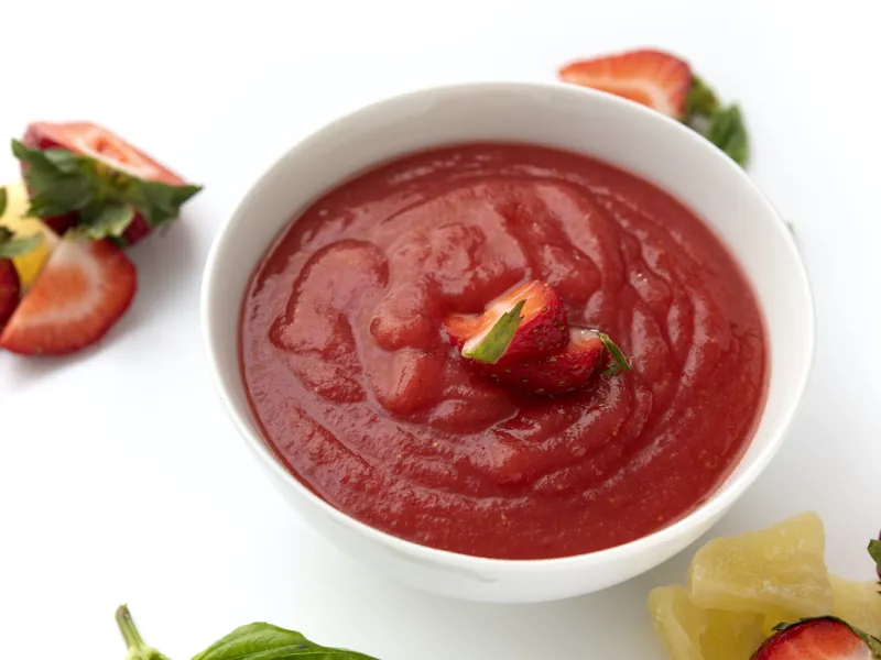 Bowl of strawberry sauce topping
