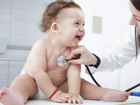 Happy baby visiting the pediatrician