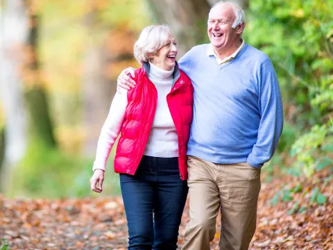 A happy older couple walking outdoors.