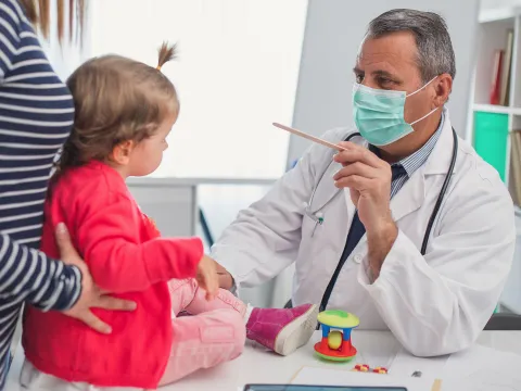 A chid at an appointment with their pediatrician. 