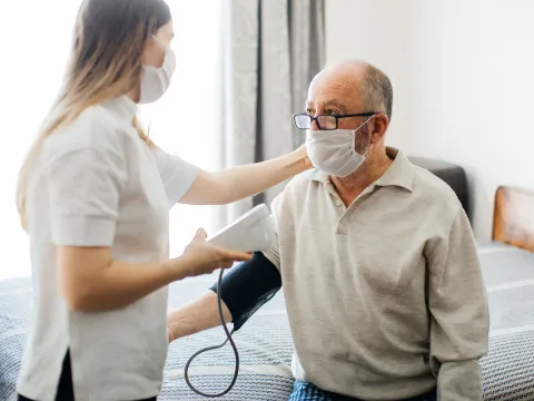 A man getting his blood pressure checked at the doctor. 