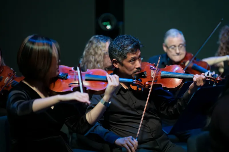 Grace Lai and Dr. Vincent Hsu with the AdventHealth employee orchestra.