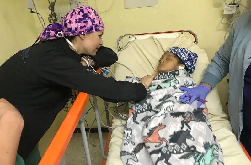 a doctor checks on a child